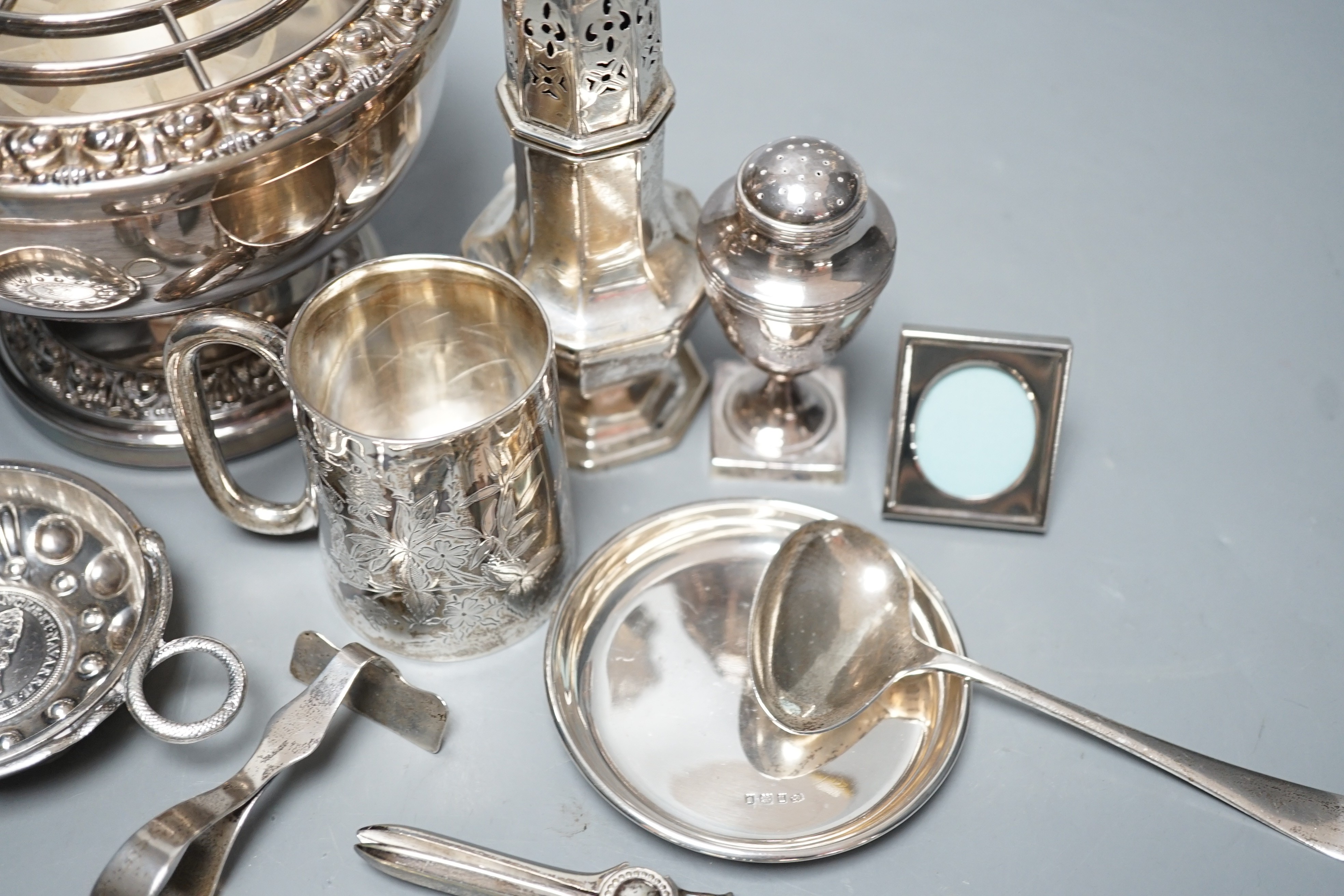A George III silver vase shaped pepperette, Richard Evans? London, 1788, 88mm, a Victorian silver christening mug, a later silver sugar caster, a French white metal taste vin and other sundry silver and plated items.